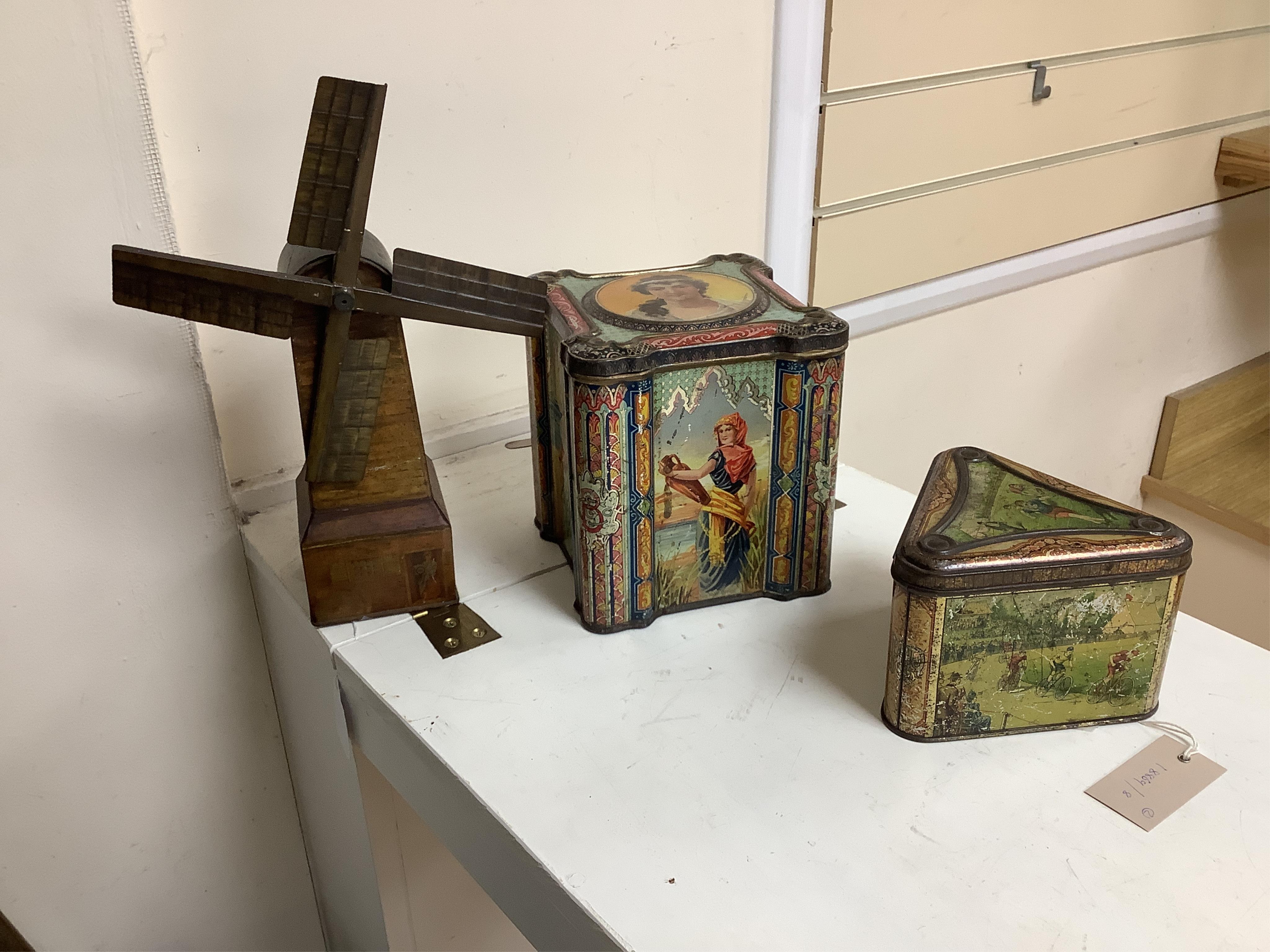 A Windmill biscuit tin by Huntley & Palmer: Reading & London, 'BIVM' Eastern Beauties tea tin and Huntley & Palmers triangular biscuit tin with 'Sports' motifs